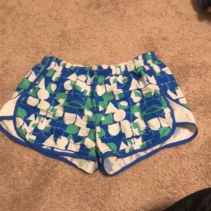 Small, athletic shorts, blue, green, and white.